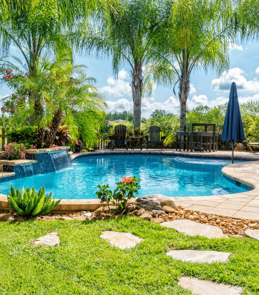 Stunning backyard oasis with an inground pool, patio, and landscaping